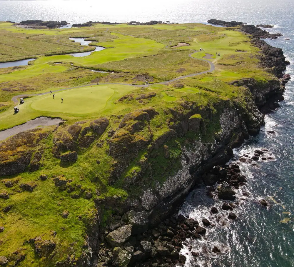 Cliff-edge greens above the surf with golfers